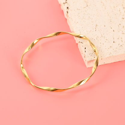 Minimalist Twisted Gold Bangle.
